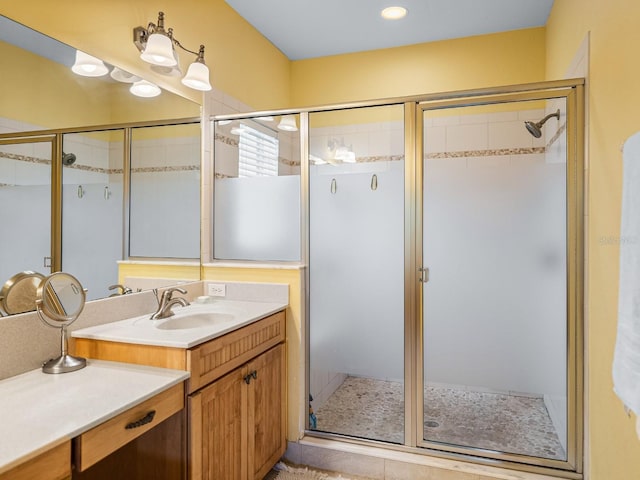 bathroom with vanity and a shower with shower door