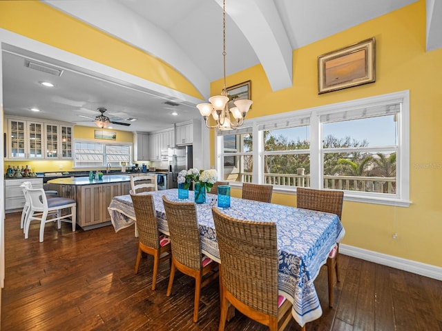 dining area featuring lofted ceiling, a healthy amount of sunlight, dark hardwood / wood-style flooring, and sink