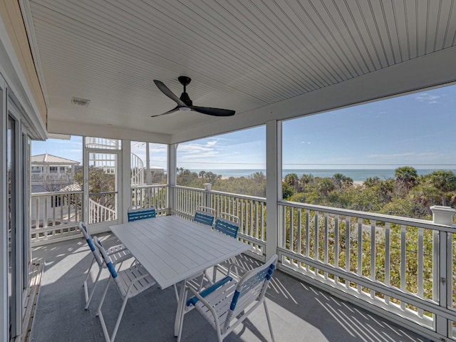 unfurnished sunroom with ceiling fan