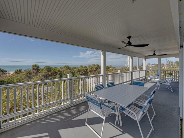 view of patio with ceiling fan and a water view