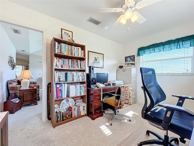 home office with a ceiling fan, carpet, and visible vents