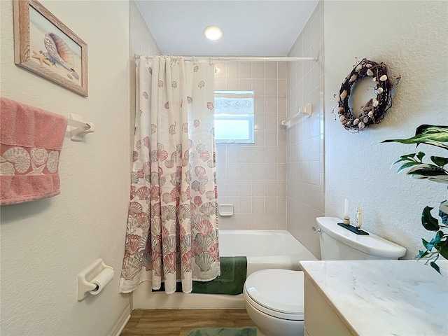 full bath featuring shower / tub combo, toilet, wood finished floors, and a textured wall