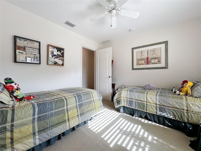 carpeted bedroom featuring visible vents and a ceiling fan