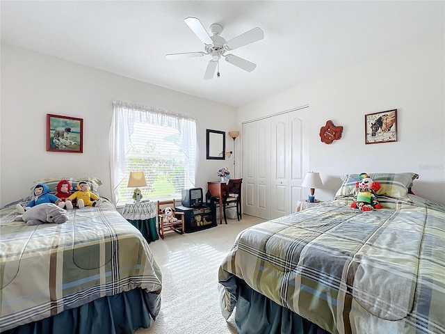 bedroom featuring ceiling fan, a closet, and light carpet