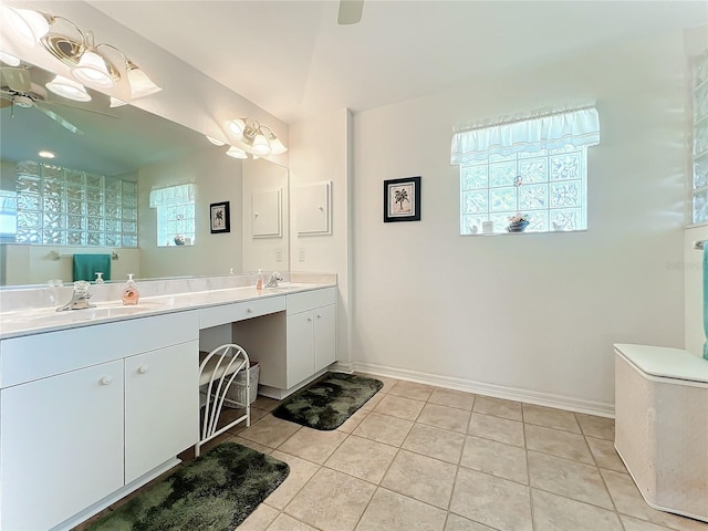 full bathroom with tile patterned floors, a ceiling fan, a sink, double vanity, and baseboards