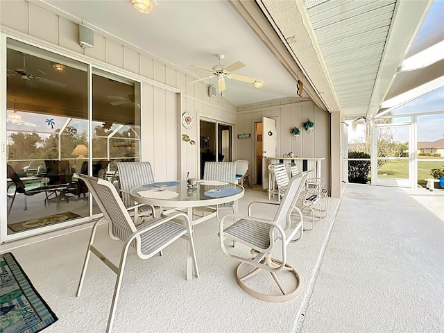 view of patio / terrace featuring a lanai, ceiling fan, and outdoor dining space