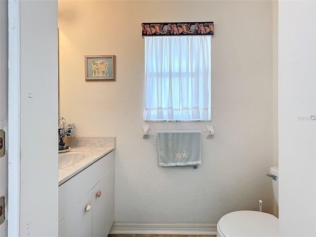 bathroom with toilet and vanity