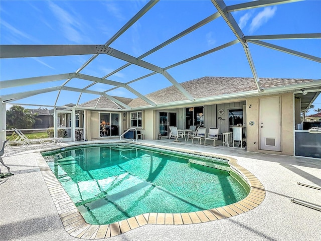 view of swimming pool with a lanai and a patio