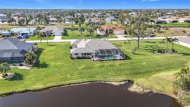 drone / aerial view with a residential view and a water view