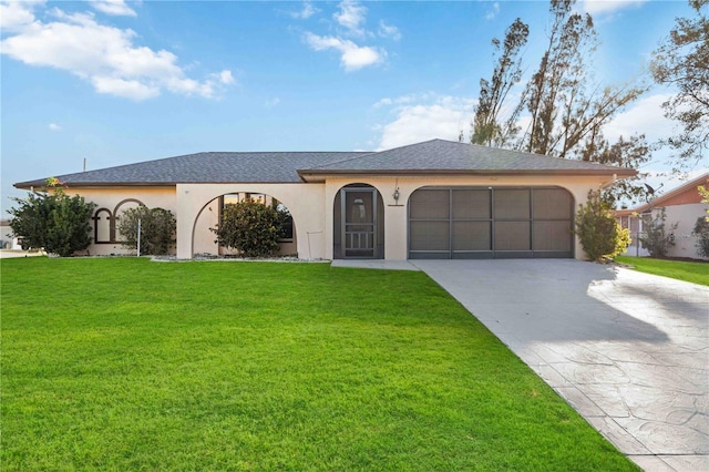 view of front of property featuring a garage and a front lawn