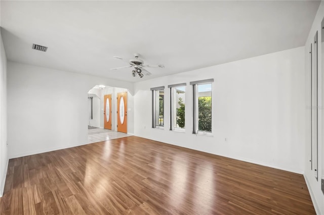 empty room with hardwood / wood-style flooring and ceiling fan