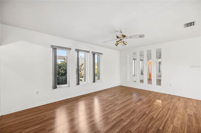 spare room with ceiling fan and wood-type flooring