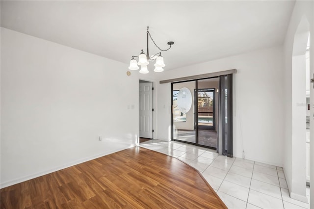 interior space with light wood-type flooring and a notable chandelier