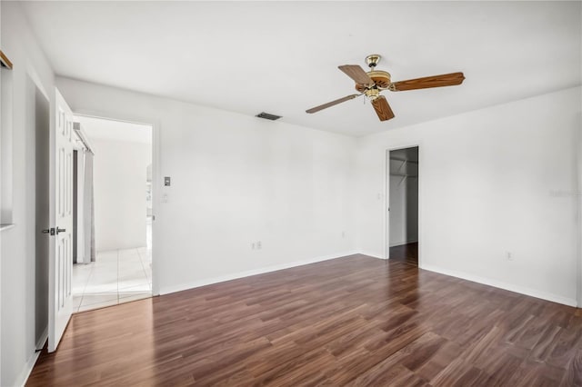 unfurnished room featuring ceiling fan and dark hardwood / wood-style flooring