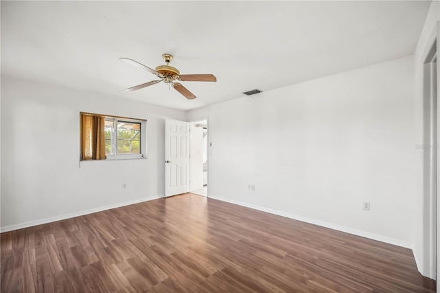 empty room featuring ceiling fan and dark hardwood / wood-style flooring