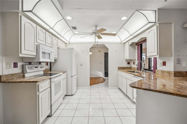 kitchen with sink, white cabinets, dark stone counters, ceiling fan, and white appliances