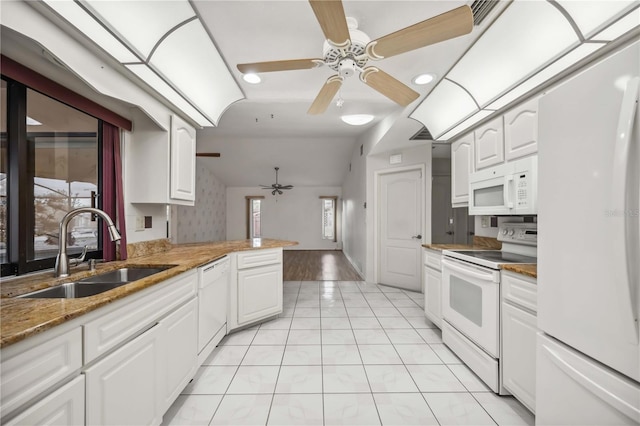 kitchen featuring white appliances, sink, and white cabinets