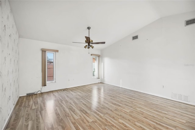 spare room with vaulted ceiling, ceiling fan, and light hardwood / wood-style floors