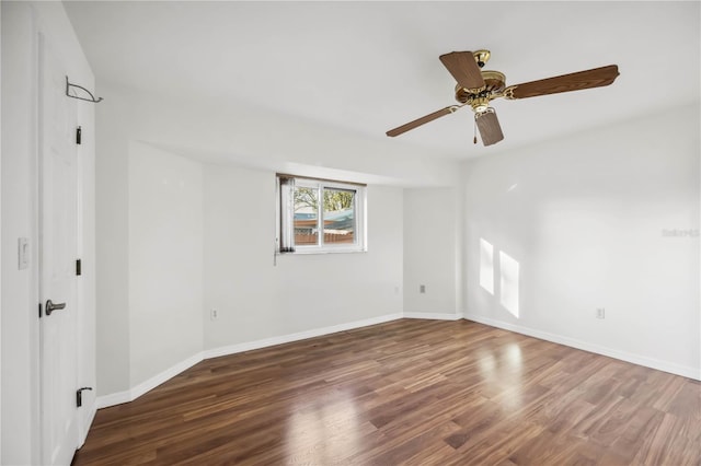 empty room with dark hardwood / wood-style floors and ceiling fan