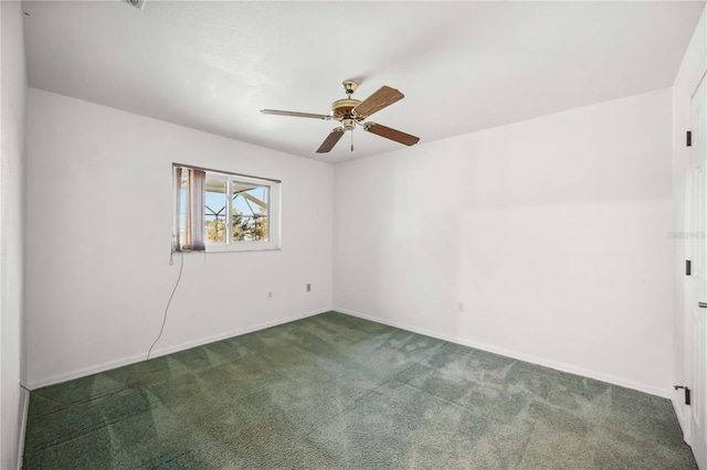 empty room with ceiling fan and dark colored carpet