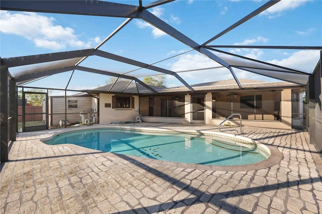 view of pool featuring a patio and glass enclosure