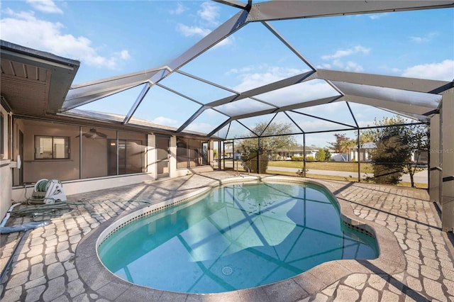 view of swimming pool with a patio area and glass enclosure