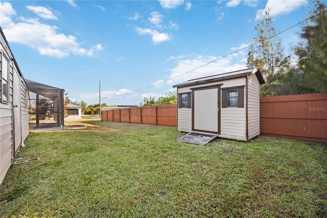 view of yard with a storage shed and a lanai