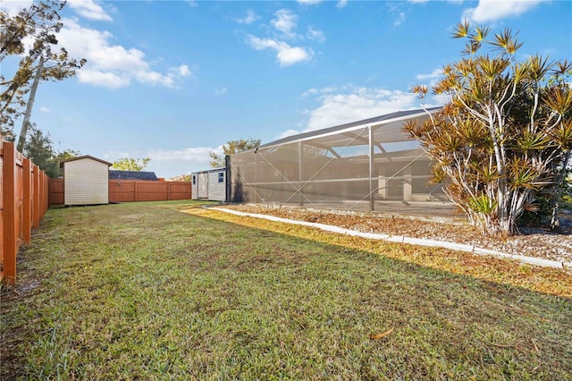 view of yard with a lanai and a shed