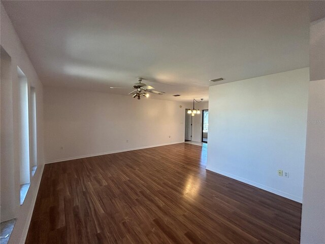 4204 Cockrell St, Port Charlotte, FL 33948 - unfurnished room with baseboards, dark wood-type flooring, visible vents, and ceiling fan with notable chandelier