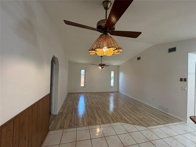 4204 Cockrell St, Port Charlotte, FL 33948 - empty room with vaulted ceiling, visible vents, a ceiling fan, arched walkways, and light wood-type flooring