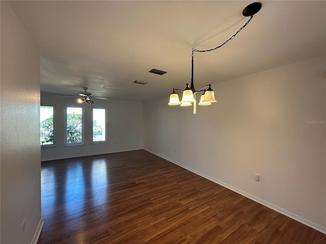 4204 Cockrell St, Port Charlotte, FL 33948 - empty room featuring baseboards, visible vents, dark wood-style floors, and ceiling fan with notable chandelier