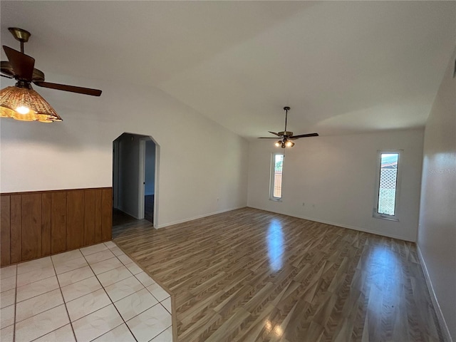 4204 Cockrell St, Port Charlotte, FL 33948 - spare room with lofted ceiling, wooden walls, a ceiling fan, wainscoting, and light wood-style flooring