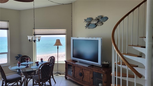 dining area featuring tile patterned flooring and a water view