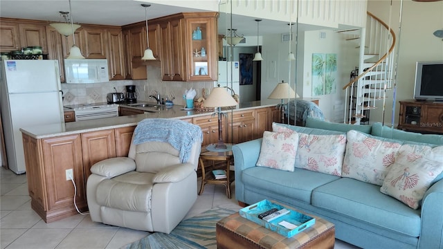 living room featuring sink and light tile patterned flooring