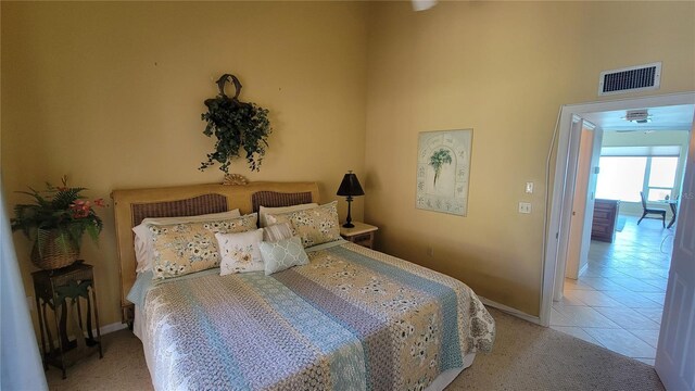 tiled bedroom with a high ceiling