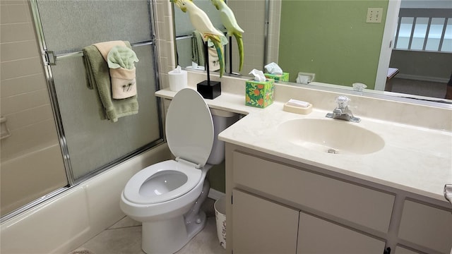 full bathroom featuring toilet, vanity, shower / bath combination with glass door, and tile patterned flooring