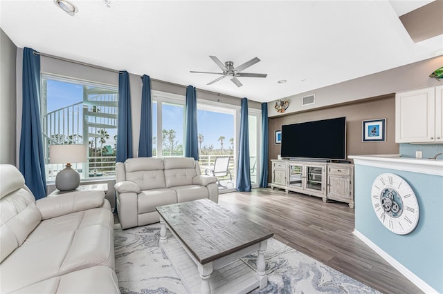 living room featuring ceiling fan and wood-type flooring