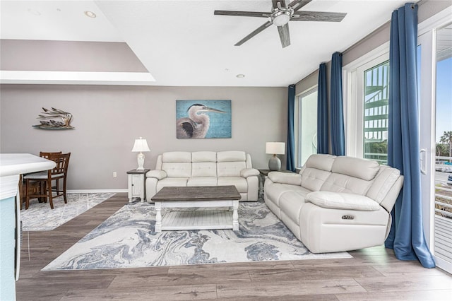 living room featuring ceiling fan and hardwood / wood-style floors