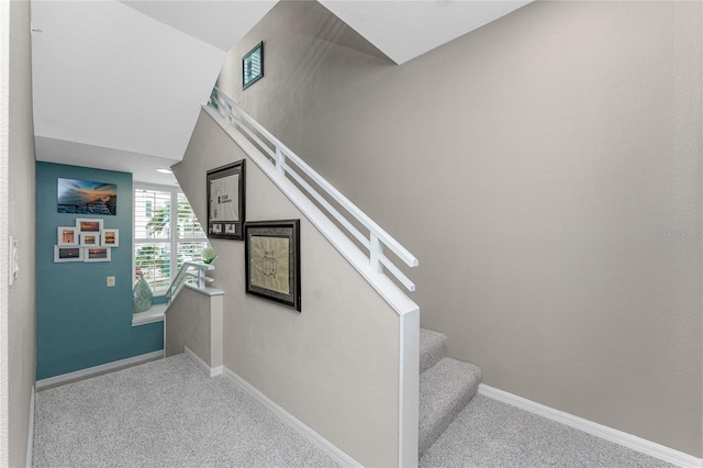 staircase with carpet and vaulted ceiling