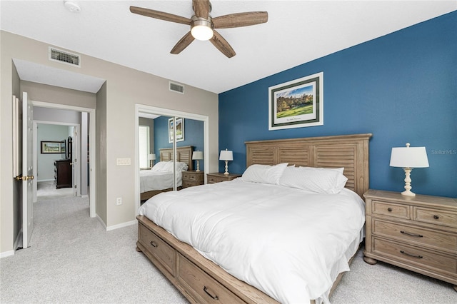 carpeted bedroom with ceiling fan and a closet