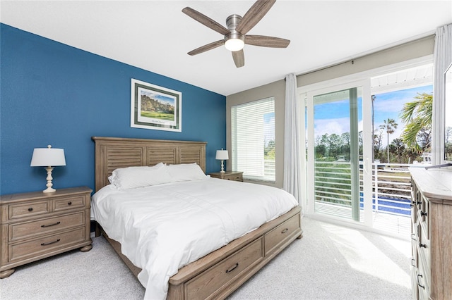 carpeted bedroom featuring ceiling fan and access to outside