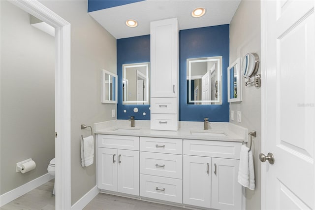 bathroom featuring toilet and vanity