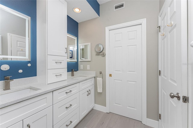 bathroom featuring vanity and hardwood / wood-style flooring