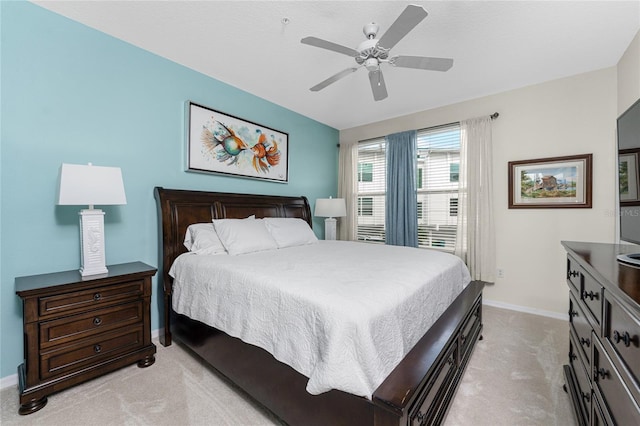 bedroom featuring light carpet and ceiling fan