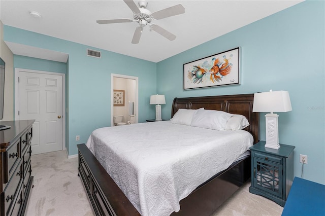 carpeted bedroom featuring ceiling fan and ensuite bath