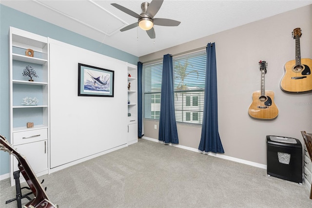 interior space with light carpet, ceiling fan, and built in features