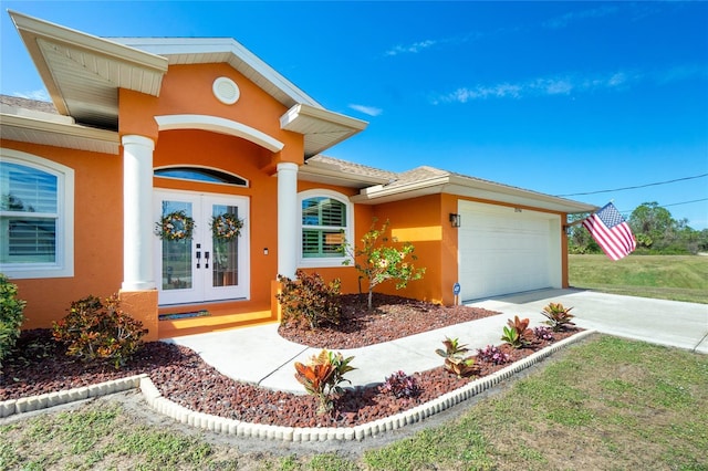 doorway to property featuring french doors and a garage