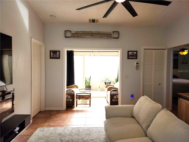 living room with ceiling fan and light tile patterned floors