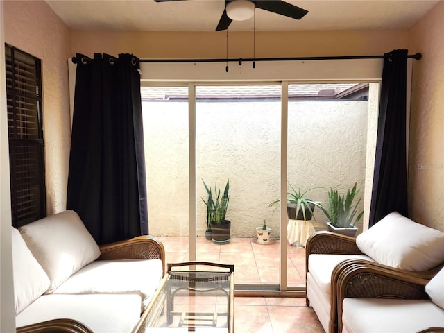 living area featuring ceiling fan and light tile patterned flooring