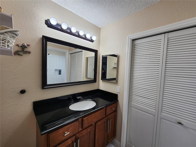 bathroom featuring vanity and a textured ceiling